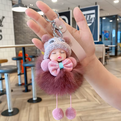 Plush keychain with a face held in a hand, indoor setting