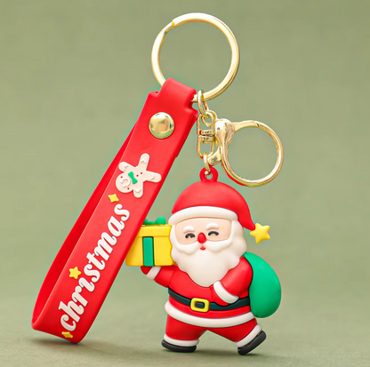 Keychain with Santa Claus figure and Christmas-themed strap on a green background