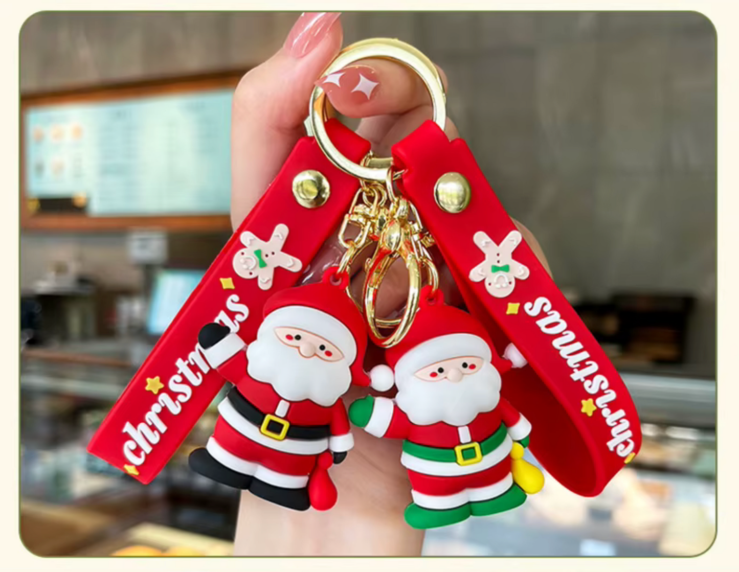 Keychain with Santa Claus figures and 'Christmas' text held by a hand.