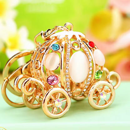 Decorative pumpkin carriage with colorful gemstones on a blurred background