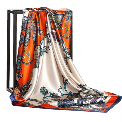 Colorful patterned scarf draped over a black stand on a white background