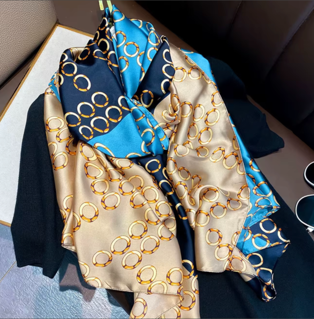 Silk scarf with gold circle pattern on a car seat