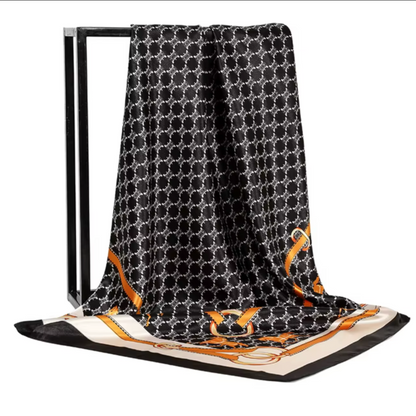 Black patterned scarf with gold accents on a white background