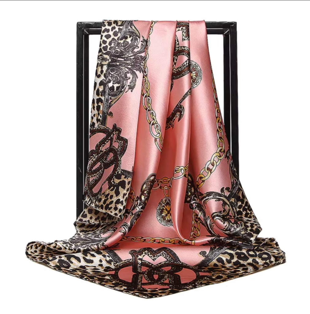 Scarf with leopard print and chain design on a pink background