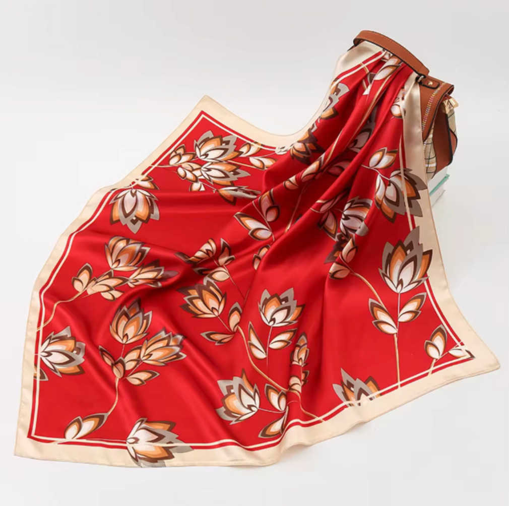 Red scarf with floral pattern on a white background